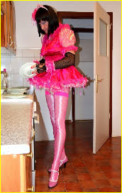 Sissy maid Carolin does the dishes in outrageously frilly pink uniform