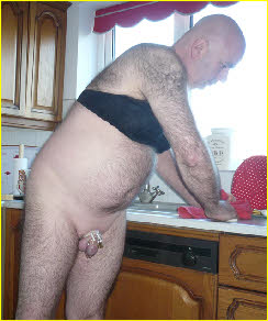 Caged sissy loser Malcolm Carter forced to do the housework wearing a bra