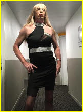 Sissy poses in revealing black dress and stockings