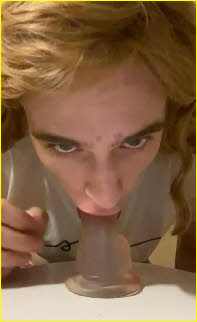 Sissy whore Maisy practises his deep throat technique on giant dildo