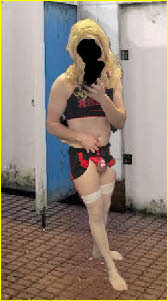 Sissy cheerleader Amber hitches up his skirt to reveal his cock cage