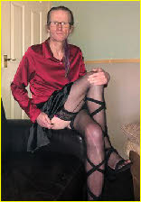Loser male Darren in silk blouse and black skirt