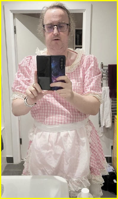 Submissive sissy maid Lucy in pink uniform with apron