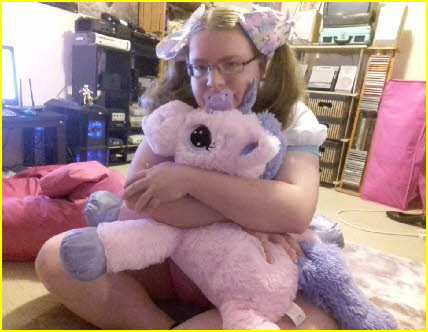 Cross-dressing adult baby Kaede hugs her My Little Pony