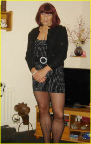 Sexy cross-dresser Sindi in minidress and stockings