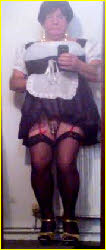 Sissy maid hitches up skirt to expose locked limp manhood Sissy maid hitches up skirt to expose locked limp manhood